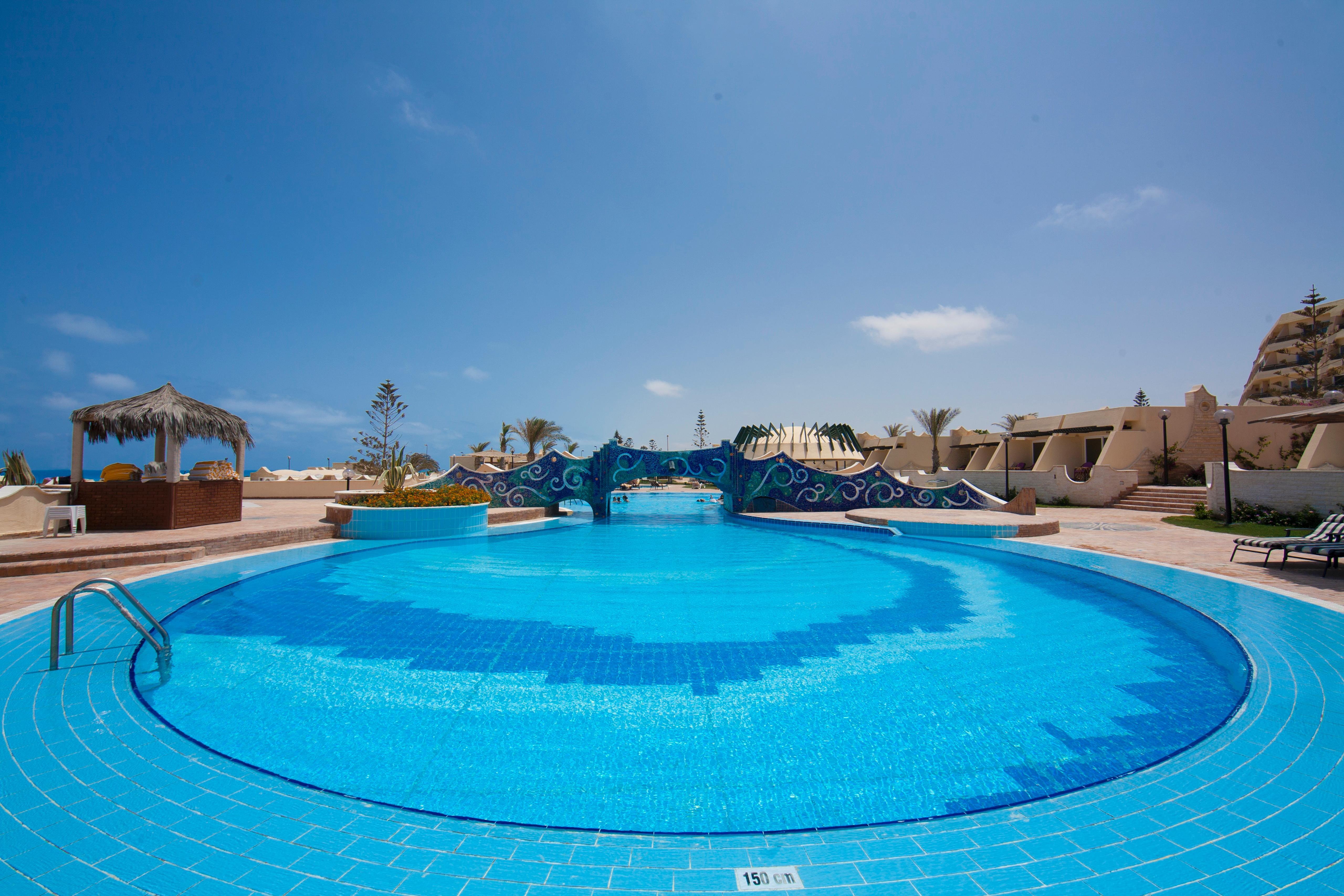 Borg El Arab Beach Resort Eksteriør billede A swimming pool at a resort in Egypt